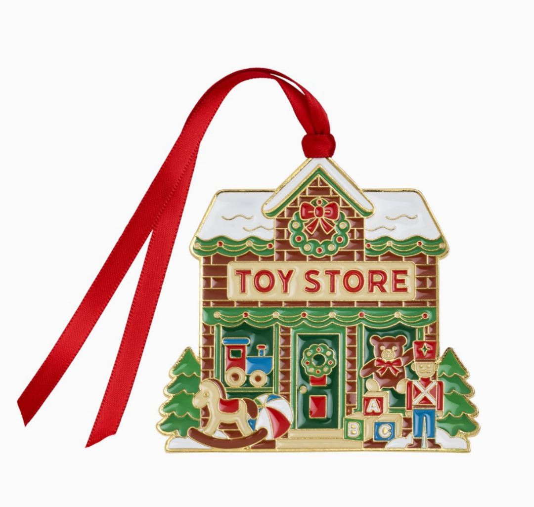 2026 Wallace gold-plated and enameled Christmas Village Toy Store ornament with wreath, toy train, teddy bear, rocking horse, blocks and toy soldier.