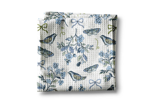 Floral and bird patterned fabric on a white background