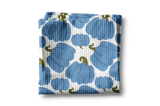 Folded fabric with blue and green pattern on a white background