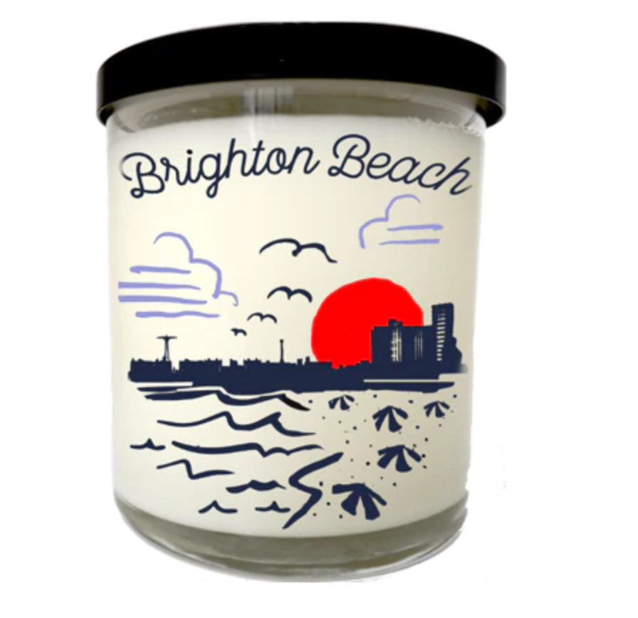 Candle with 'Brighton Beach' design on a white background