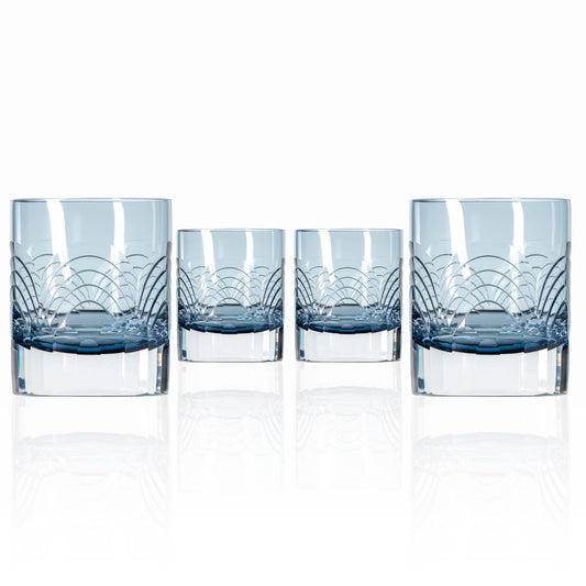 Set of four blue-rimmed glass tumblers on a white background