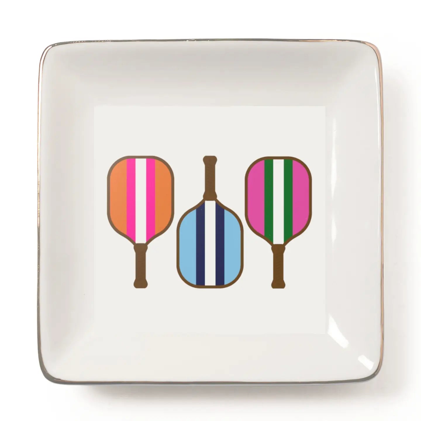 A square white ceramic plate with a metallic gold rim, featuring a graphic print of three paddle-shaped objects with colorful vertical stripes (orange, pink, white; blue, navy, white; pink, green, white) on a clean white background.