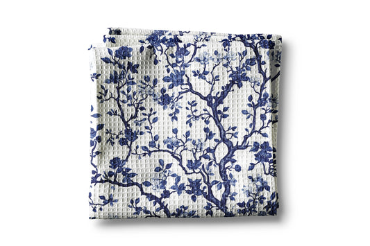 Folded fabric with blue floral pattern on a white background