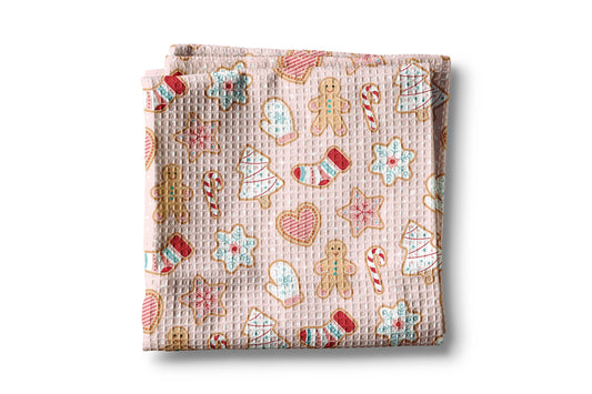 Folded fabric with Christmas-themed cookies pattern on a white background
