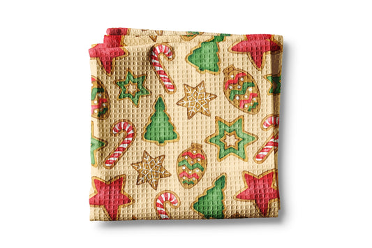 Waffle-textured towel with Christmas-themed cookies and candy design on a beige background