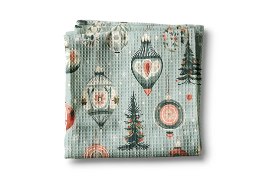 Folded fabric with Christmas-themed pattern on a white background