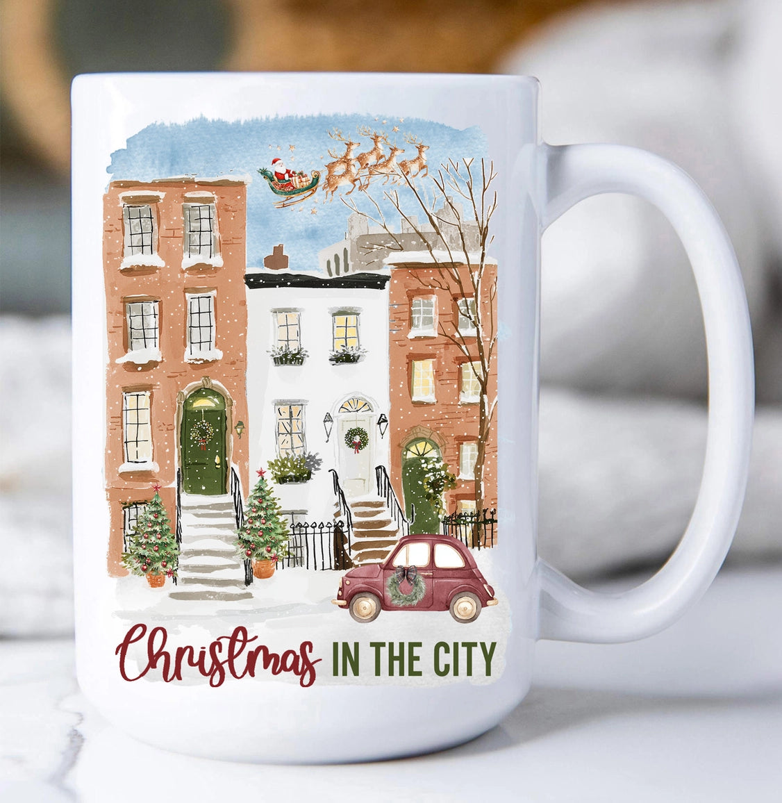 White mug with a Christmas-themed design of a city street scene and text 'Christmas in the City'.