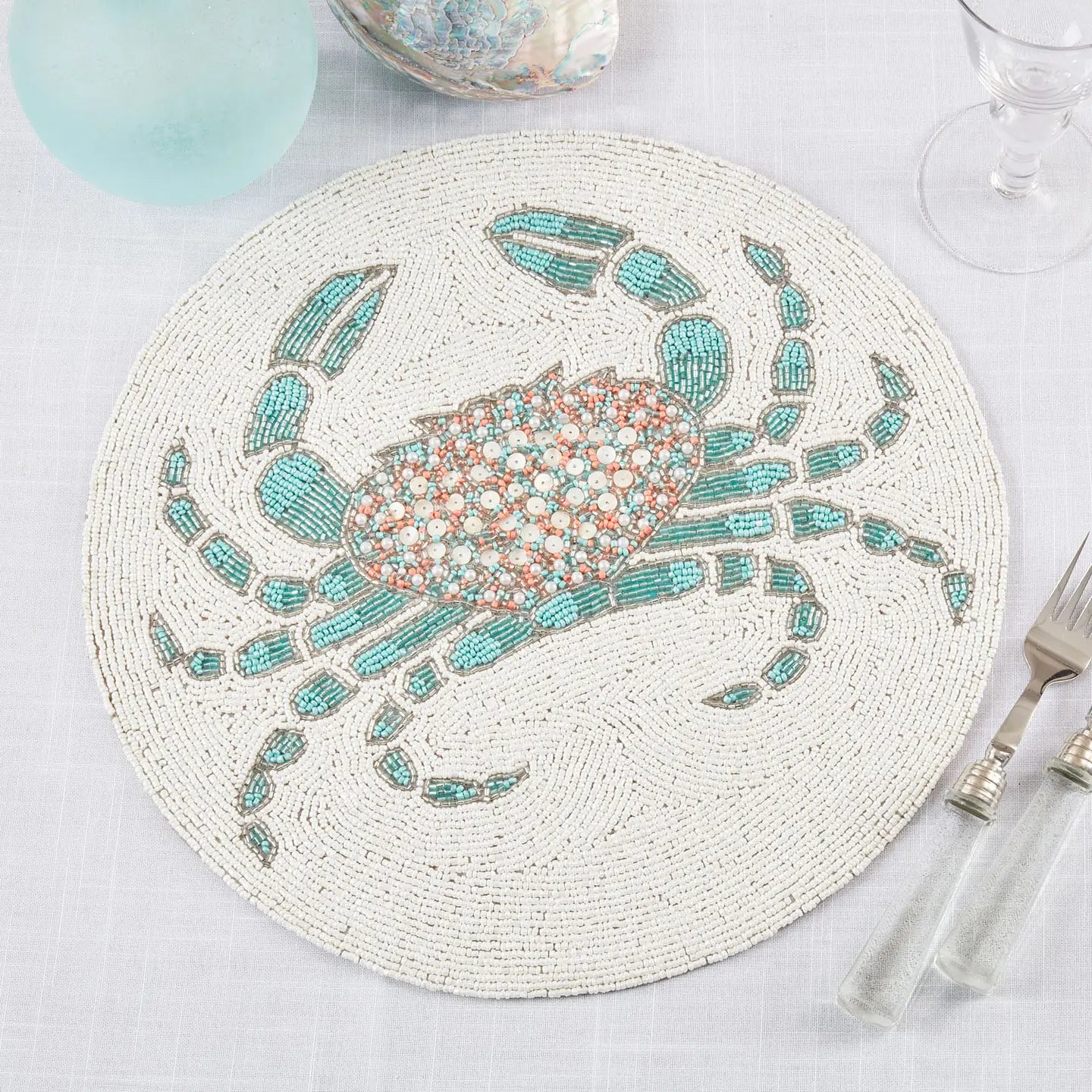 Round placemat with a crab design on a table setting