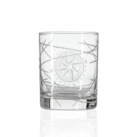 Clear glass tumbler with compass design on a white background