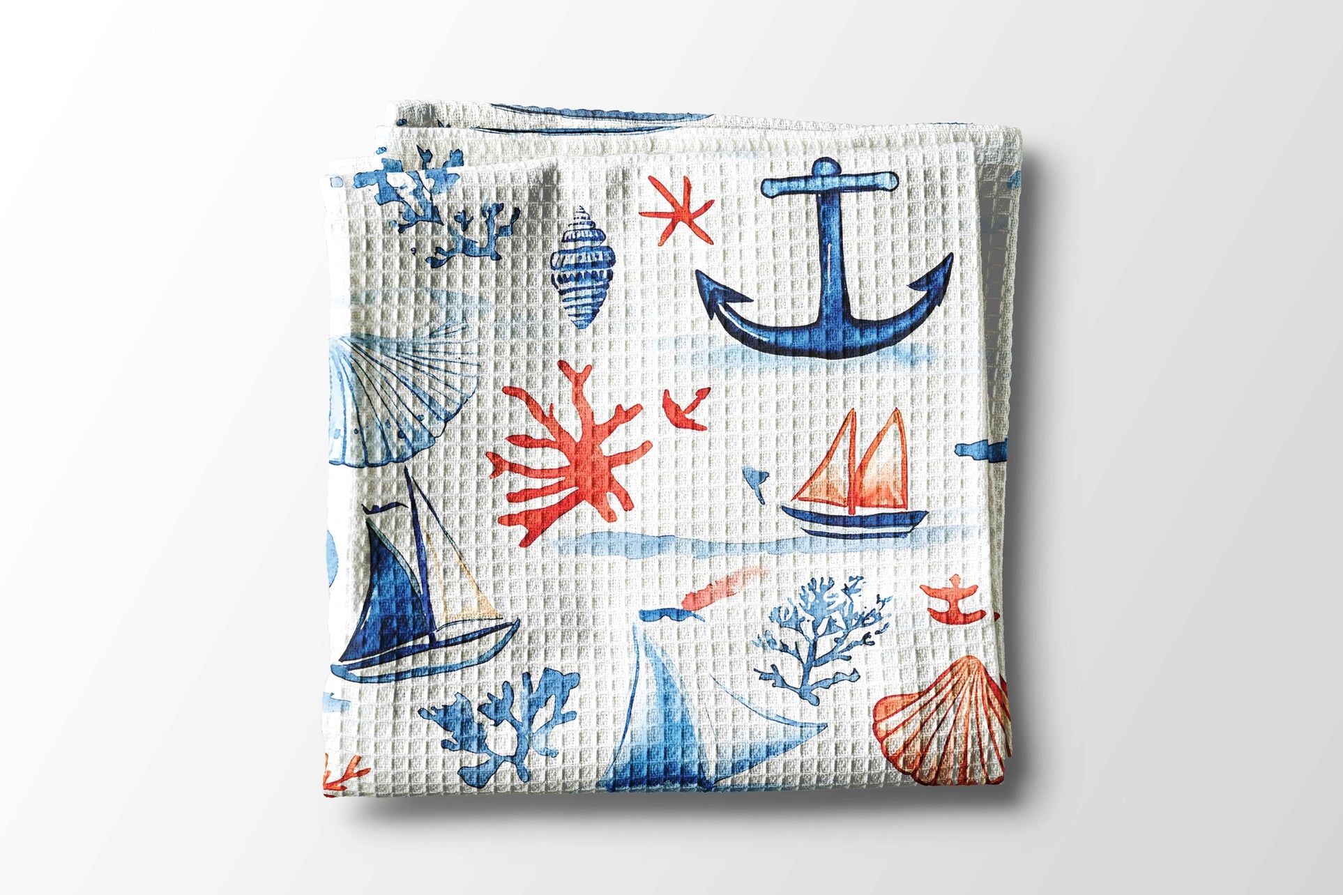 Waffle-textured towel with nautical pattern on a white background