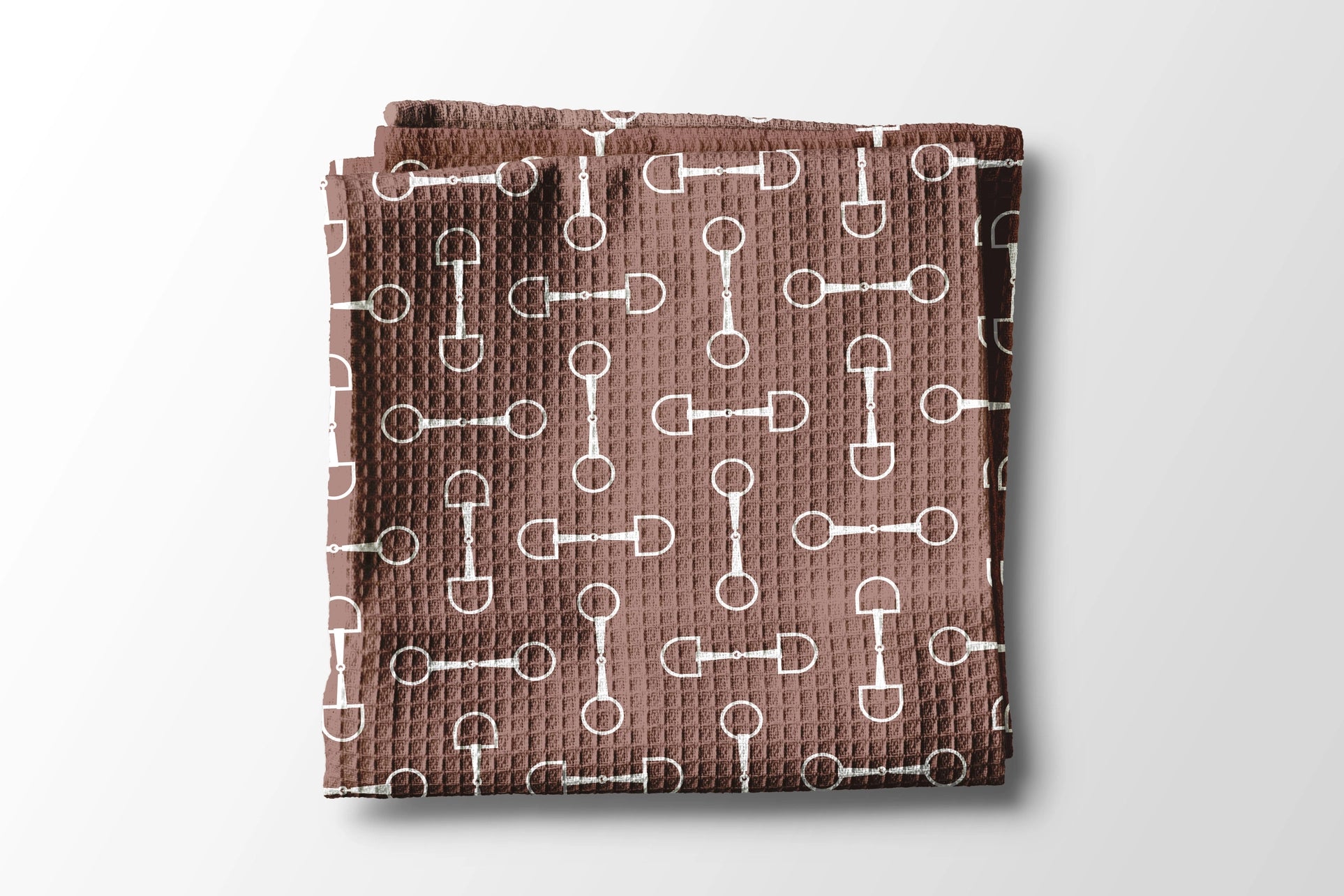 Brown towel with white pattern on a light gray background