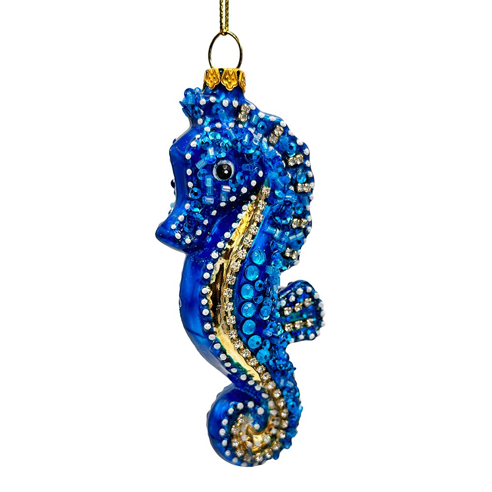 Decorative blue seahorse ornament with gold accents on a white background