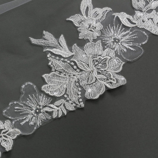 Decorative floral lace trim on a dark background