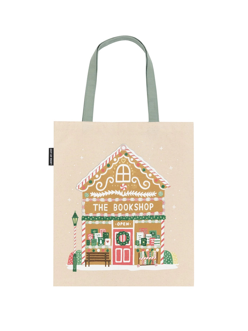 Tote bag with a gingerbread house design labeled 'The Bookshop' on a beige background