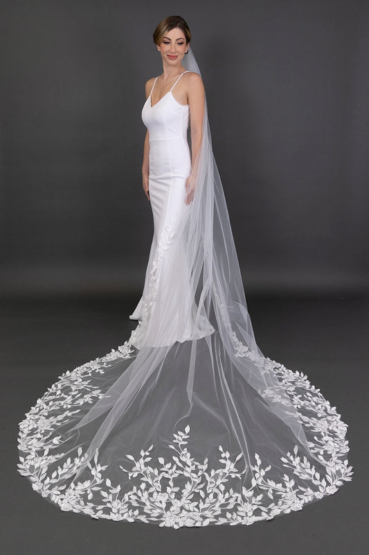 White wedding dress with a long, elegant veil on a dark background