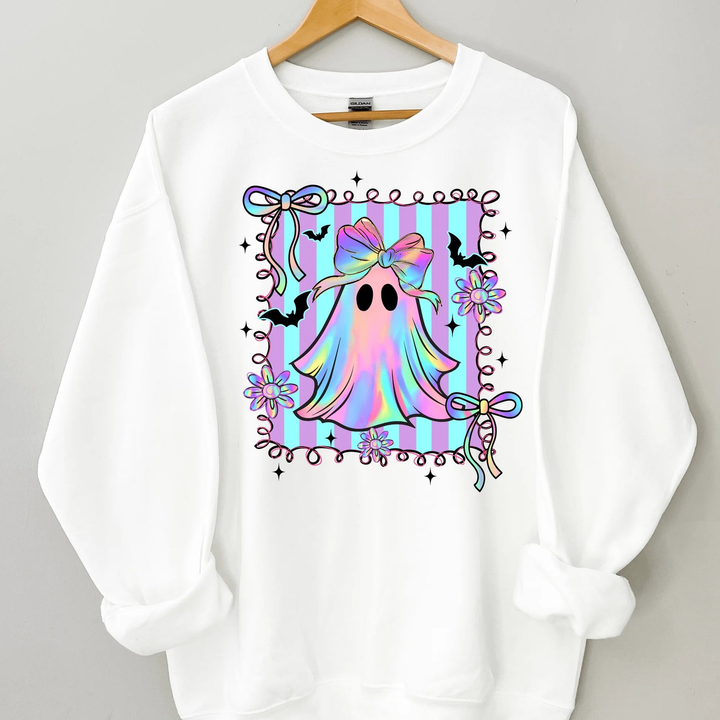 White sweatshirt with a colorful ghost design on a gray background
