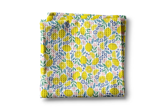 Floral patterned fabric with yellow flowers on a white background
