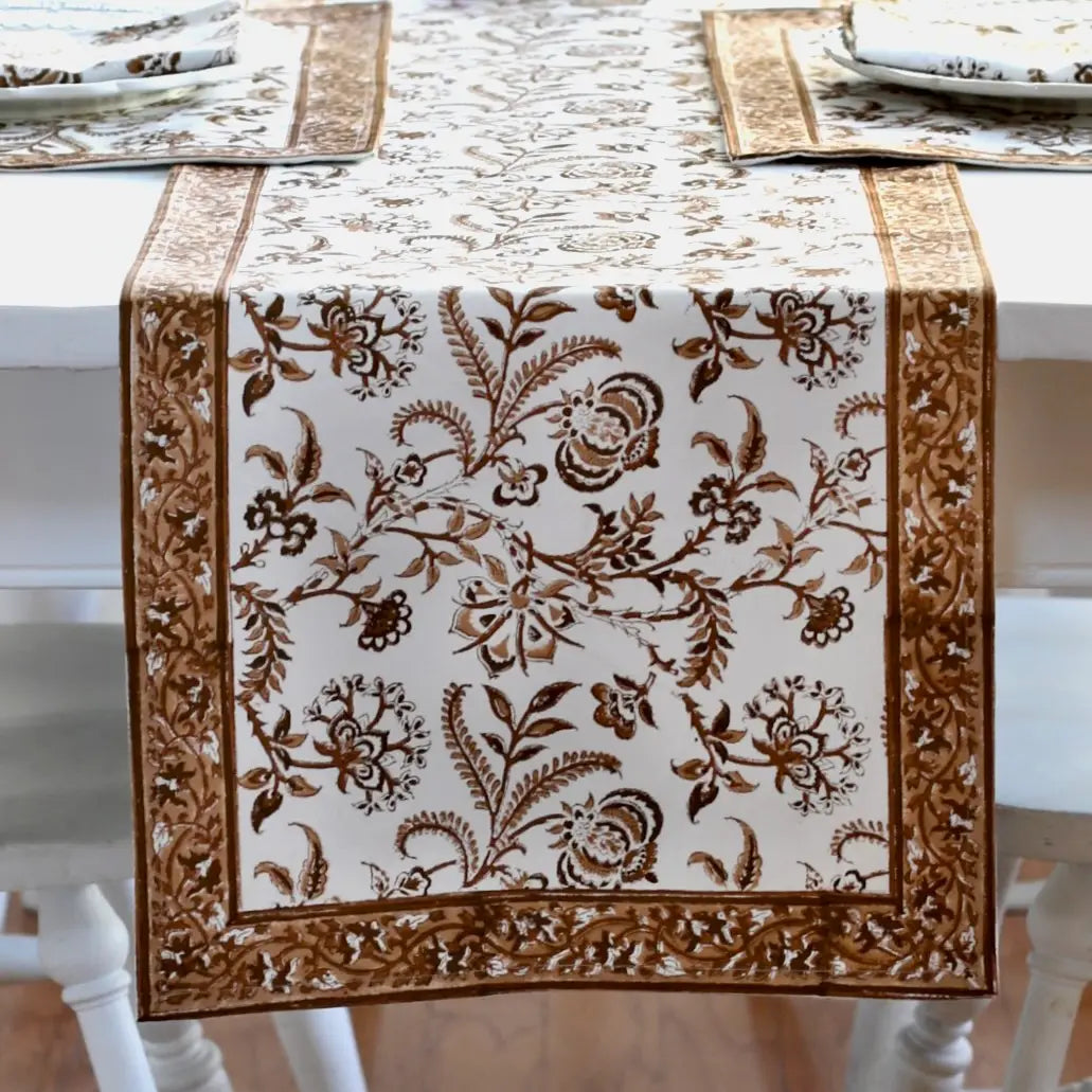 Decorative table runner with floral pattern on a white table