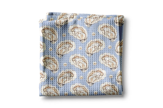 Folded fabric with oyster pattern on a light blue background