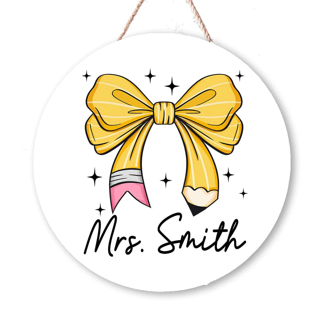 Circular sign with a yellow bow and pencil design, personalized with 'Mrs. Smith'.
