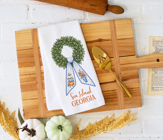 Personalized chinoiserie fall waffle weave kitchen towel displayed on a wooden serving board with pumpkins and autumn décor.