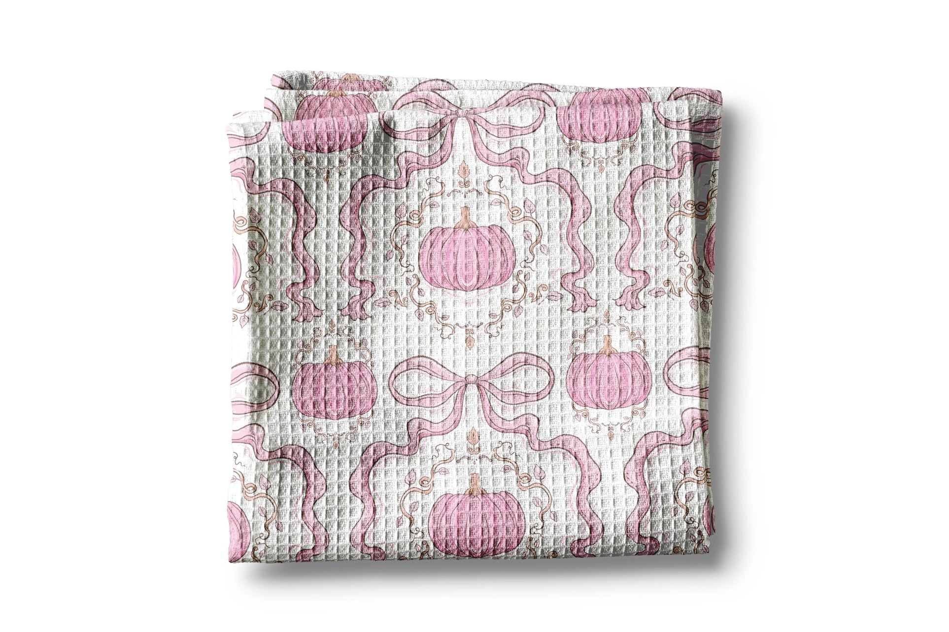 Folded fabric with pink pumpkins and ribbons pattern on a white background