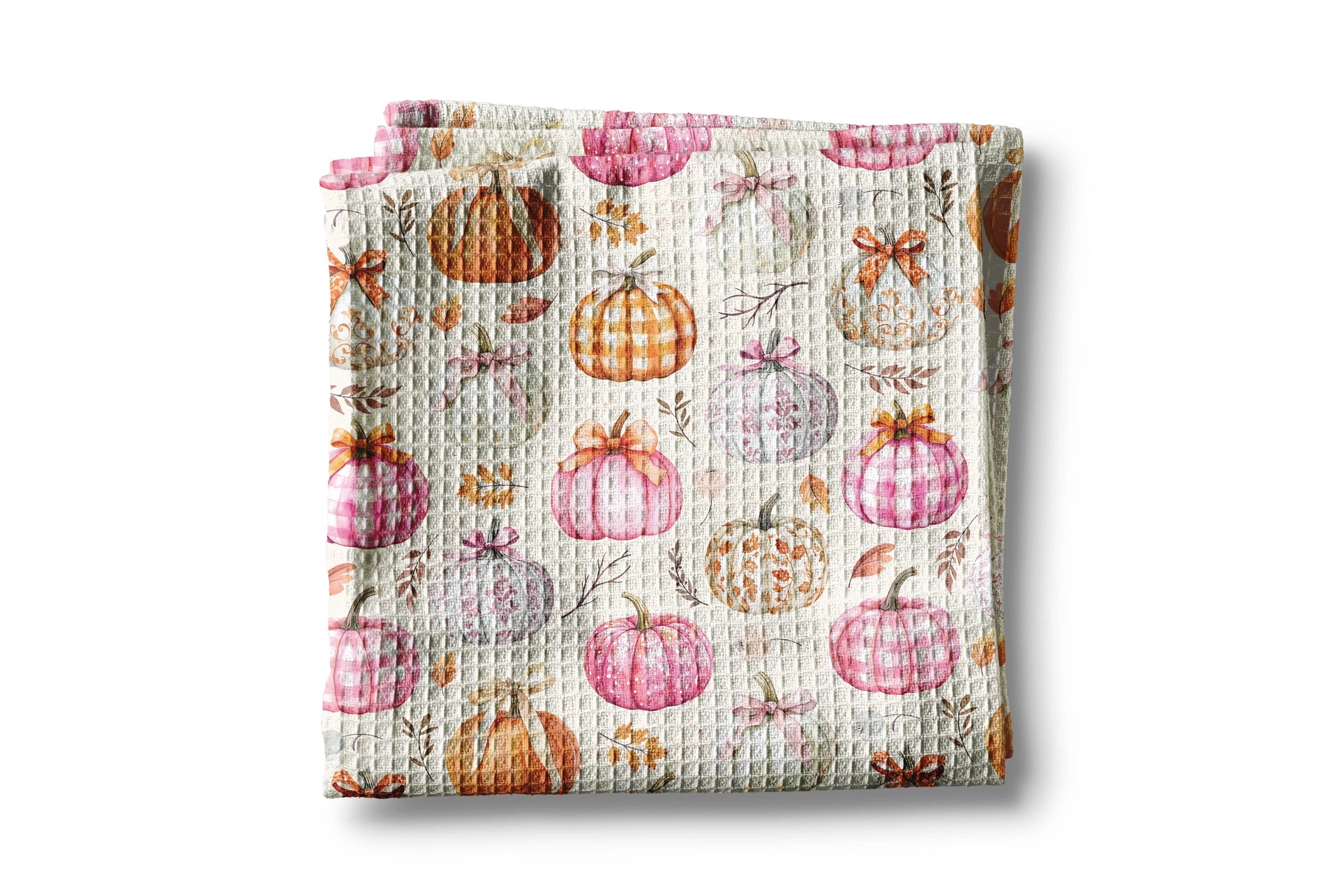 Waffle-textured blanket with pumpkins and leaves pattern on a white background