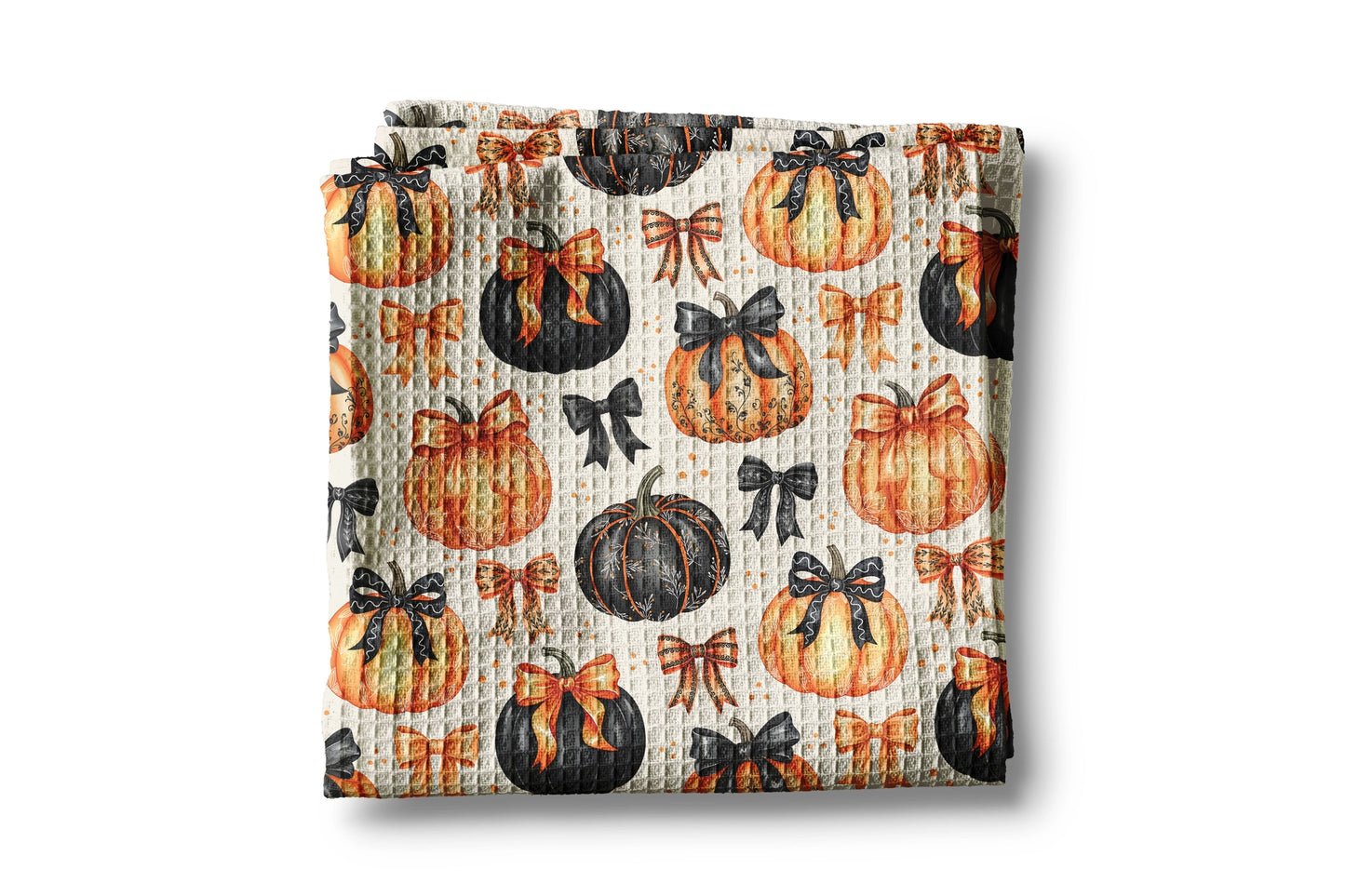 Baby blanket with pumpkin and bow pattern on a white background