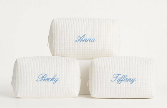Cream waffle makeup bags personalized with names in light blue script embroidery