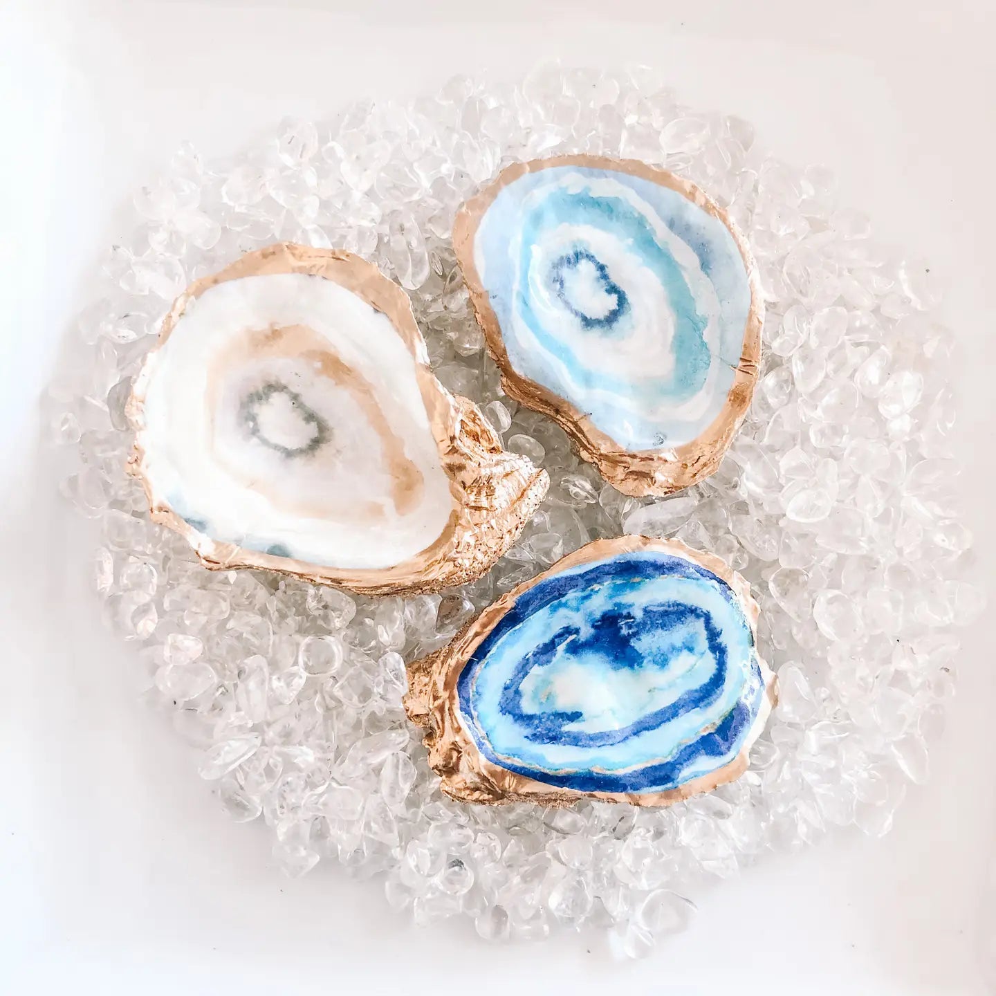 Three agate slices with blue and white patterns on a textured surface