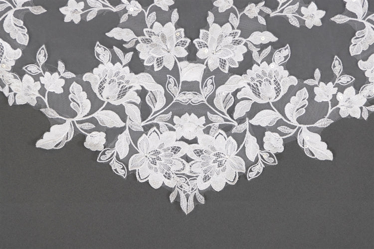 White floral lace on a dark gray background