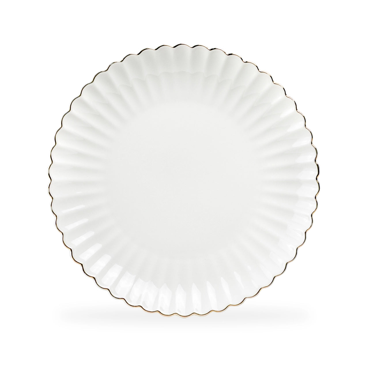 White ceramic plate with scalloped edge on a white background