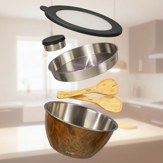Set of stainless steel and wooden kitchen utensils on a green background