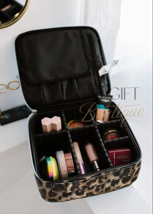 Leopard print makeup case with cosmetic products on a vanity table.