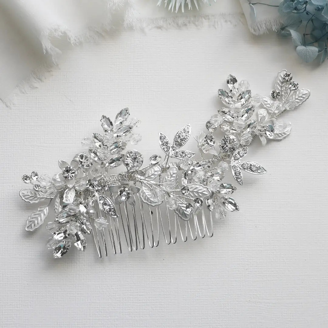 Silver hair comb with crystal embellishments on a light background