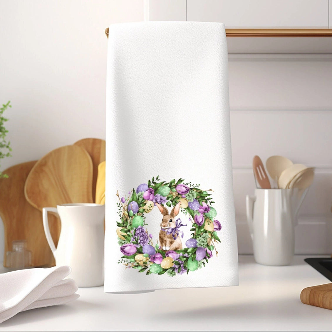 Kitchen towel with a floral wreath and bunny design on a kitchen counter.