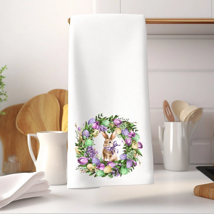 Kitchen towel with a floral wreath and bunny design on a kitchen counter.