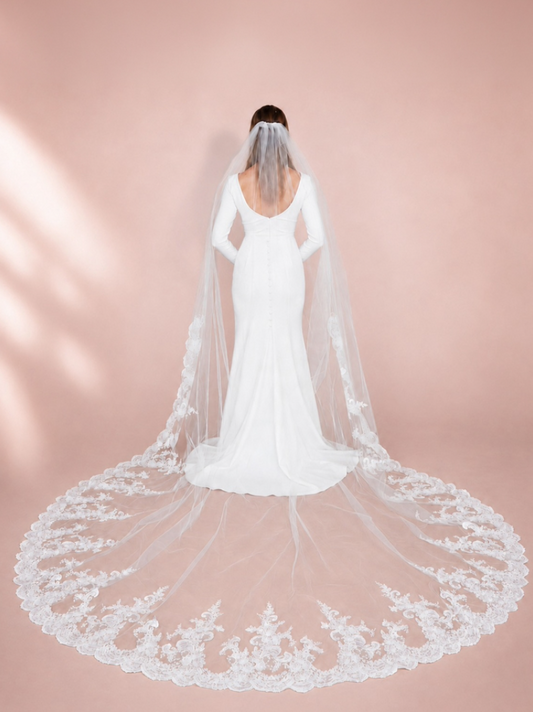 Bride wearing 120-inch ivory cathedral wedding veil with cascading botanical lace and extra-wide embroidered train