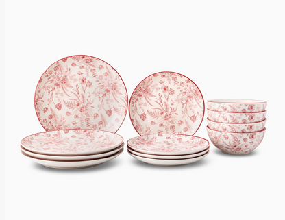 Set of ceramic plates and bowls with floral pattern on a white background