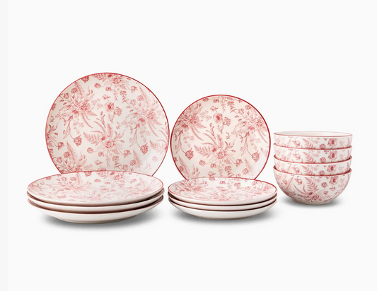 Set of ceramic plates and bowls with floral pattern on a white background