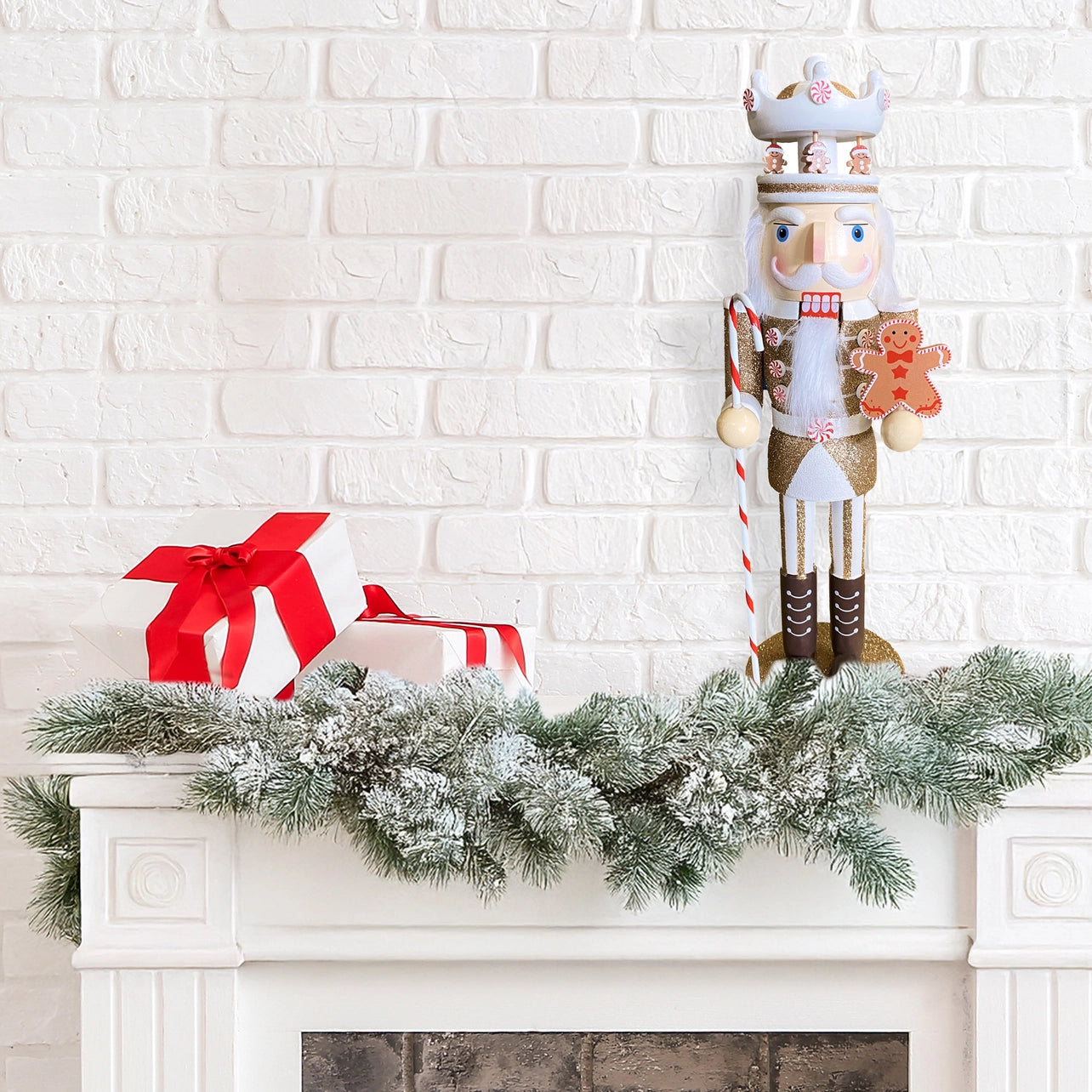 Decorative nutcracker with a gingerbread man on a mantel with a white brick wall background.
