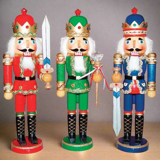 Three colorful nutcrackers in red, green, and blue outfits on a white background