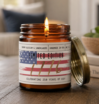 Candle in an amber jar with a label featuring an American flag design, sitting on a wooden surface.