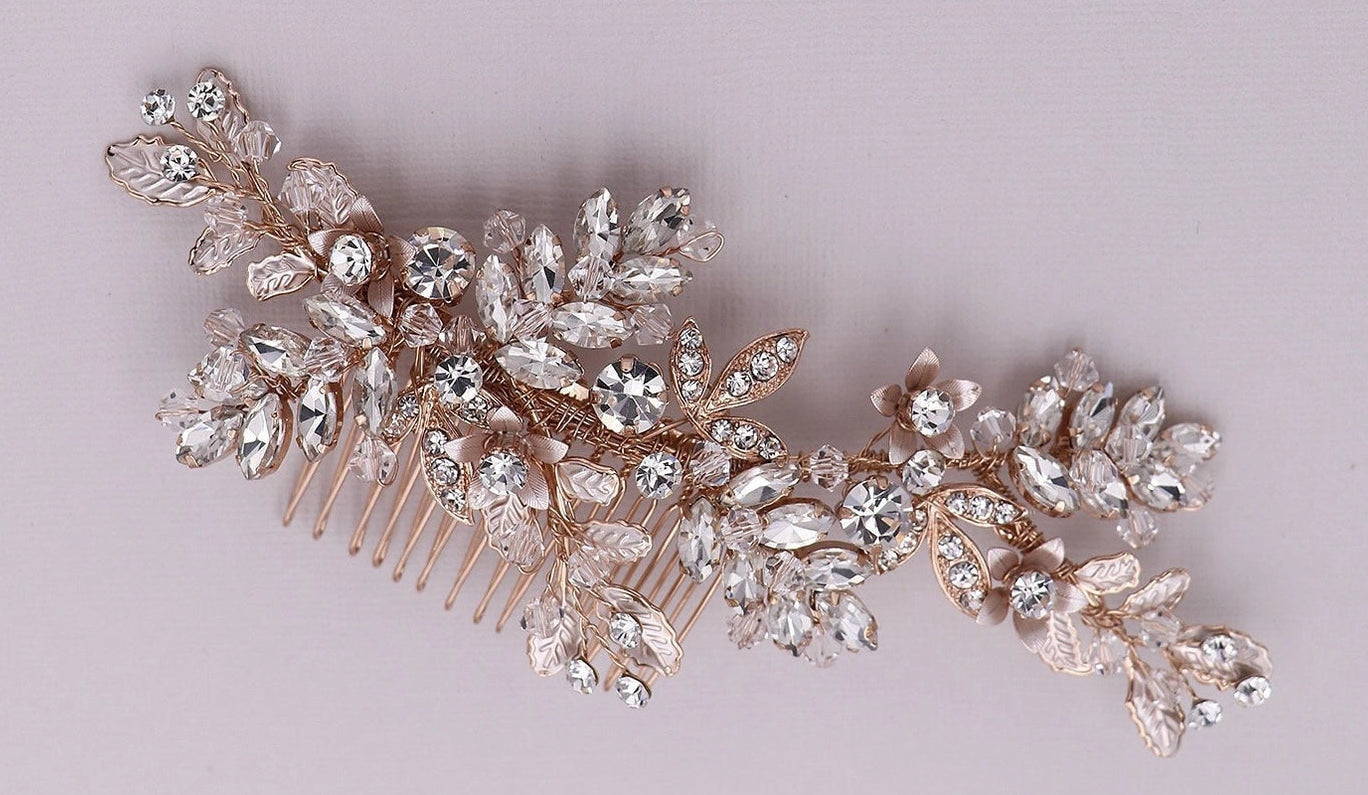 Decorative rose gold hair comb with crystals on a light gray background