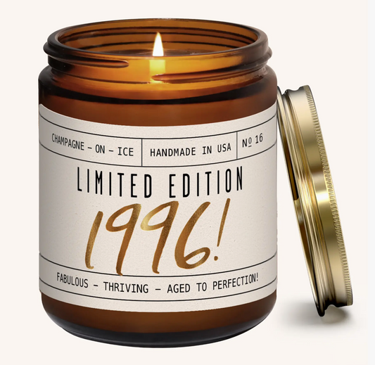 Candle in an amber jar with a label indicating 'Limited Edition 1996' on a white background