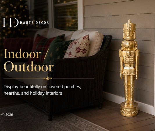 A tall decorative gold nutcracker stands on a wooden porch beside a dark wicker outdoor chair with patterned pillows. Text on the left reads 'HD HAUTE DECOR' and 'Indoor / Outdoor', with additional copy about displaying decor on covered porches and hearths.