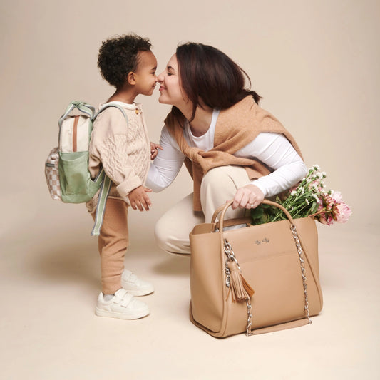 Woman and child with a beige handbag on a beige background