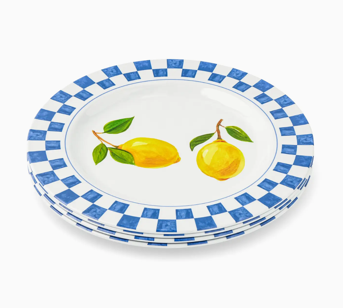 Set of plates with lemon design and blue checkered border on a white background