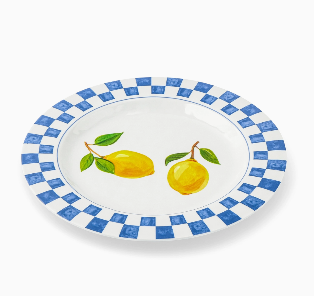 Decorative plate with blue checkered border and lemon design on a white background
