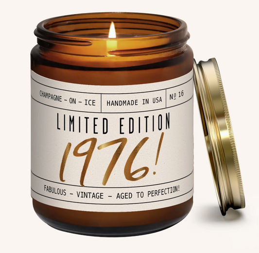Candle in an amber jar with a label reading 'Limited Edition 1976' on a white background